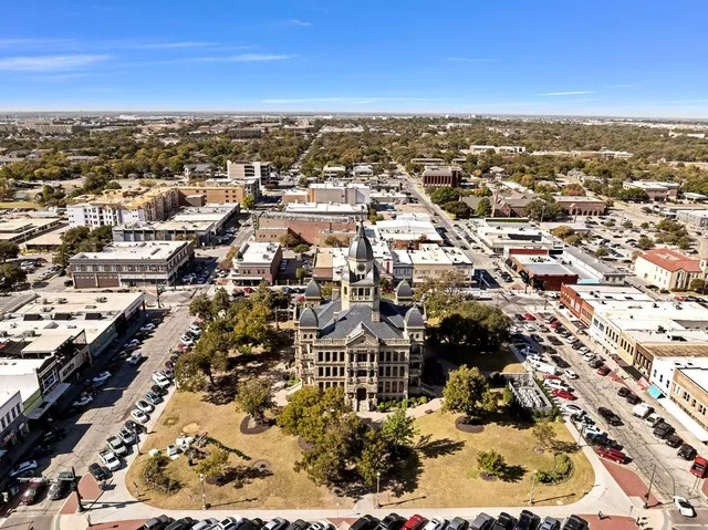 an aerial view of residential houses with city view