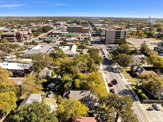 an aerial view of residential building and trees around
