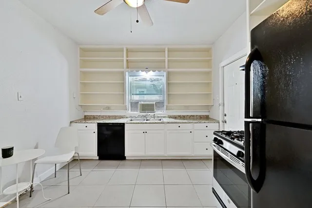 a kitchen with a refrigerator and a stove top oven