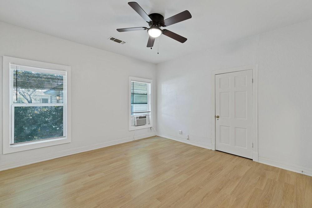 608 West Hickory Street, Unit B Denton, TX 76201 - Photo 6 of 19 an empty room with windows and fan