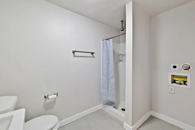 a bathroom with a toilet and a shower