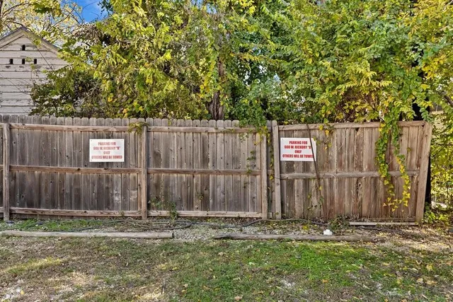 a wooden fence with trees in the background