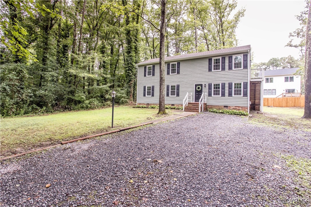 Colonial home featuring crawl space and a front la