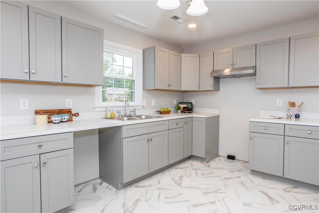 7856 Epic Road Richmond, VA 23235 - Photo 24 of 32 Kitchen with gray cabinetry, under cabinet range h