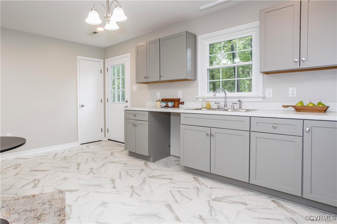 7856 Epic Road Richmond, VA 23235 - Photo 26 of 32 Kitchen with gray cabinetry, a chandelier, light c