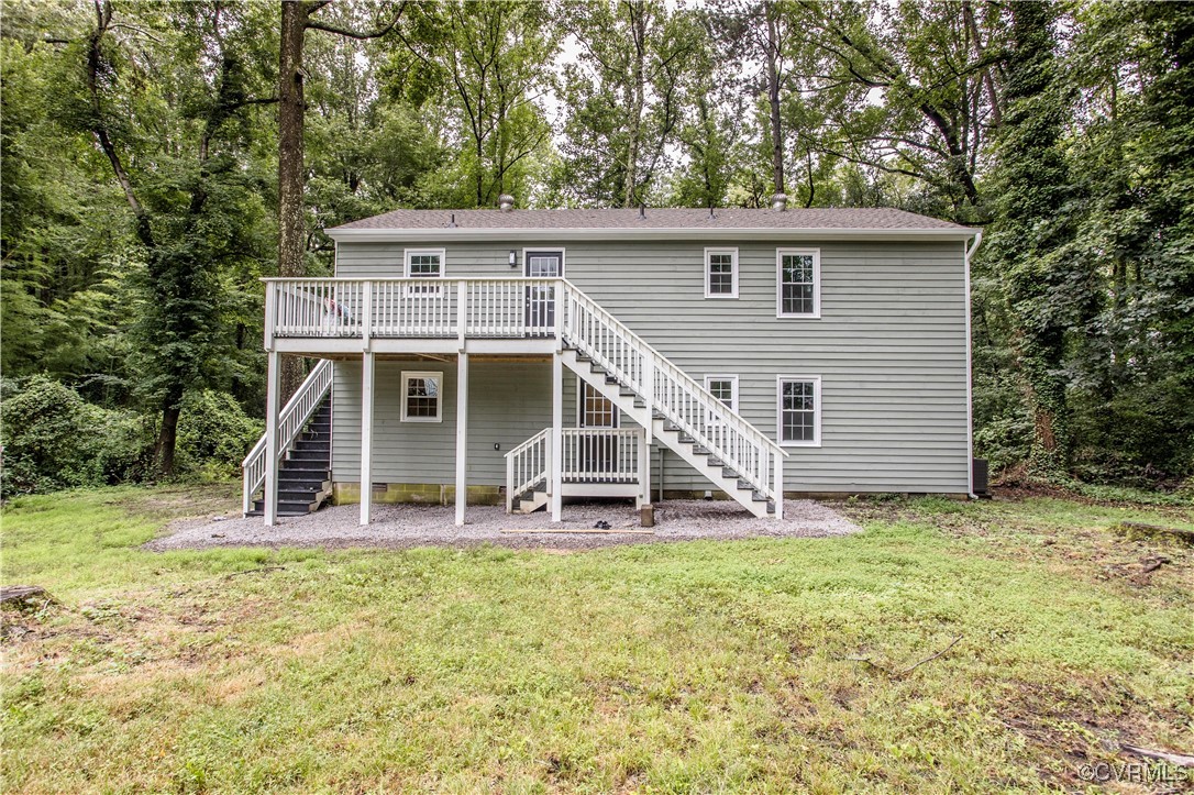 Back of house featuring stairway, a wooden deck, a