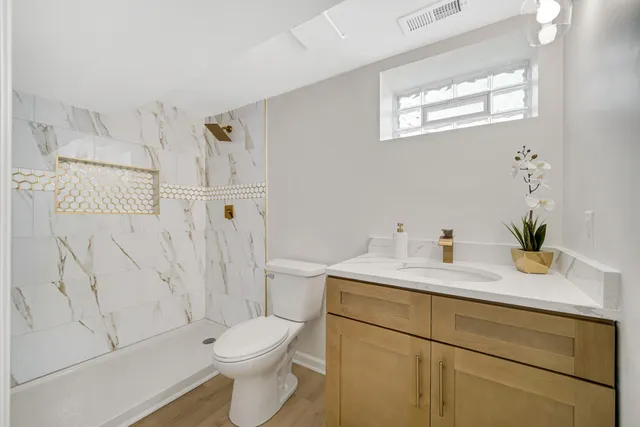 a white toilet sitting next to a bathroom sink