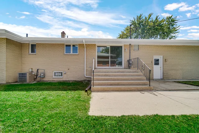 a view of backyard with barbeque grill and potted plants