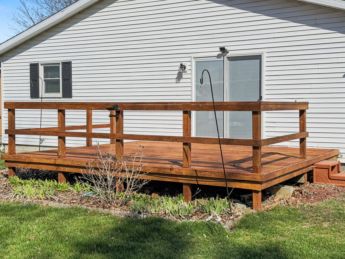 707 East Ash Street Watseka, IL 60970 - Photo 14 of 14 a backyard of a house with wooden deck and outdoor seating