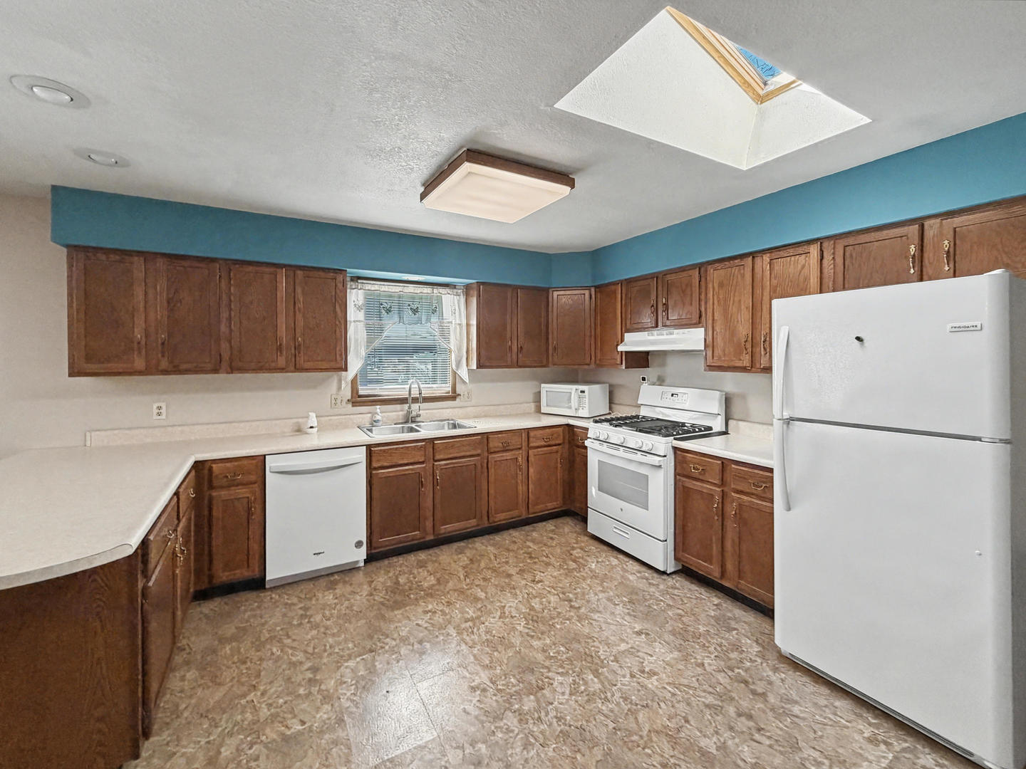 707 East Ash Street Watseka, IL 60970 - Photo 5 of 14 a kitchen with granite countertop a refrigerator stove top oven a sink and dishwasher