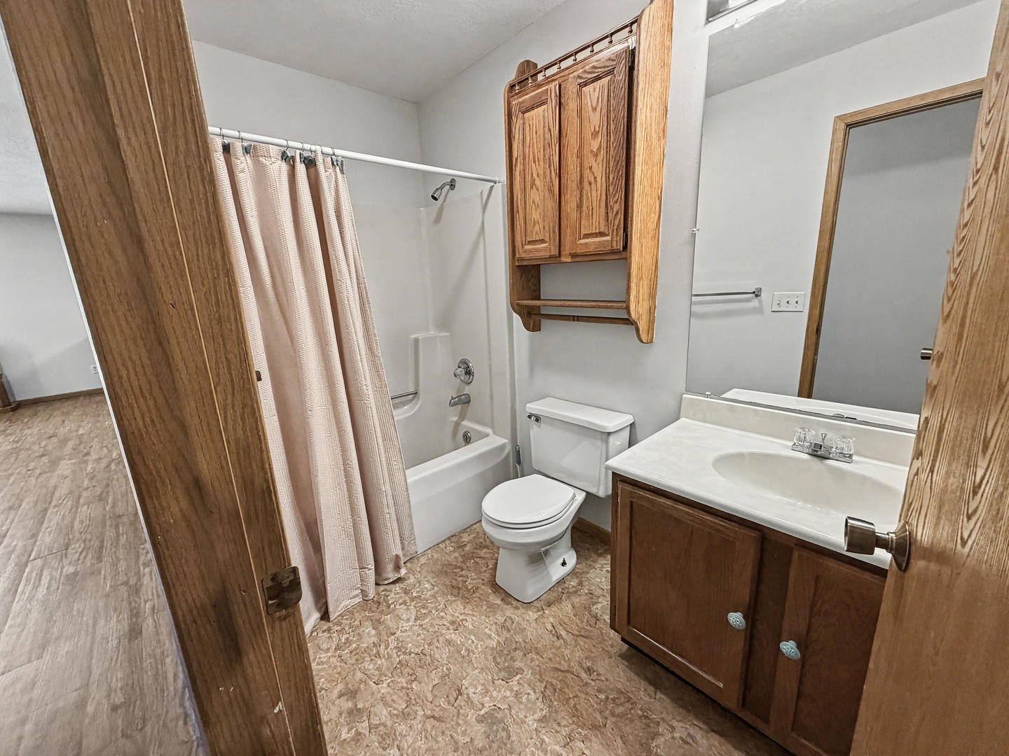 707 East Ash Street Watseka, IL 60970 - Photo 7 of 14 a bathroom with a sink a toilet a mirror and shower
