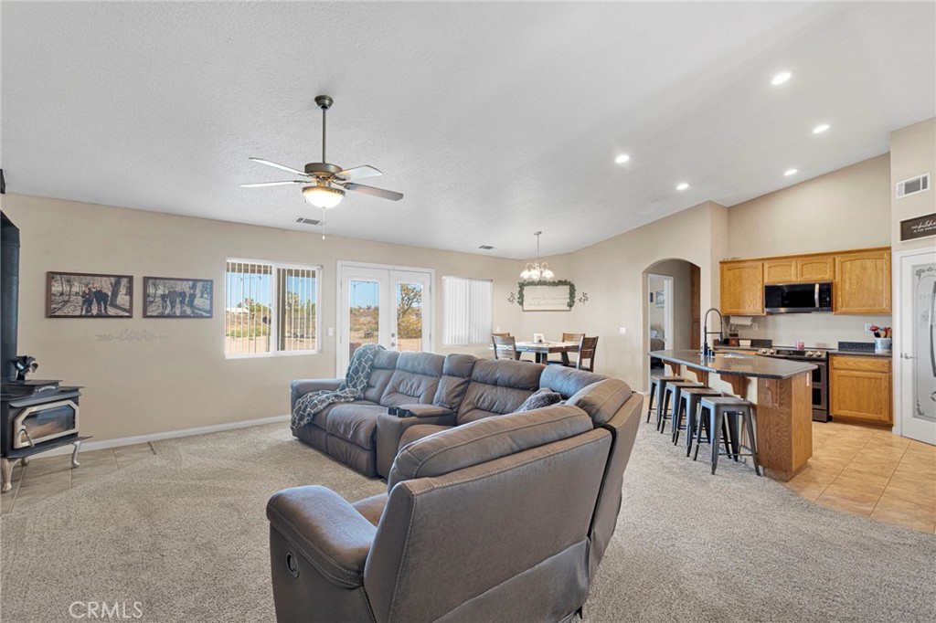 12871 Alta Vista Road Pinon Hills, CA 92372 - Photo 13 of 40 a living room with furniture a dining table and kitchen view