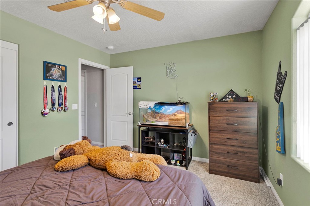 12871 Alta Vista Road Pinon Hills, CA 92372 - Photo 18 of 40 a bedroom with a bed and a cabinets