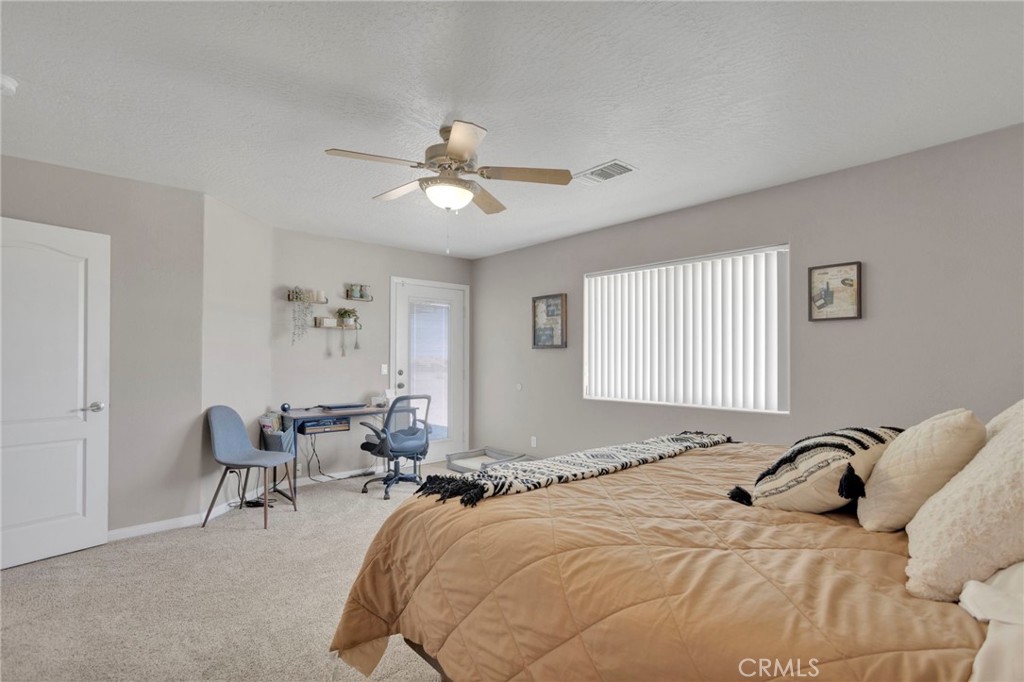 12871 Alta Vista Road Pinon Hills, CA 92372 - Photo 30 of 40 a bed room with a bed and a chair