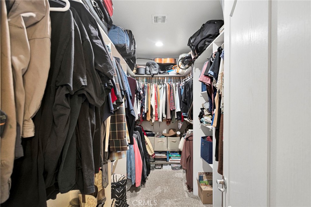 12871 Alta Vista Road Pinon Hills, CA 92372 - Photo 34 of 40 a view of walk in closet with clothes