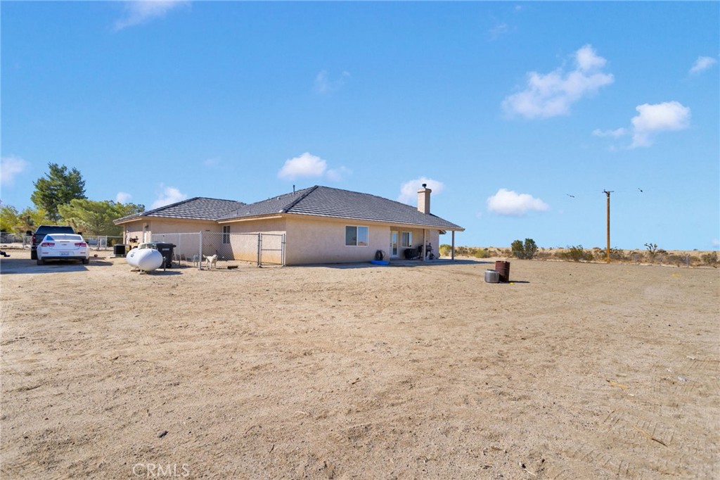 12871 Alta Vista Road Pinon Hills, CA 92372 - Photo 37 of 40 a front view of a house with a yard and garage