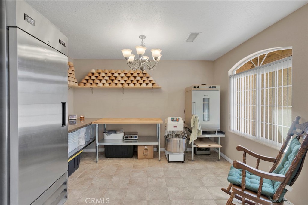 12871 Alta Vista Road Pinon Hills, CA 92372 - Photo 4 of 40 a bedroom with furniture and a chandelier