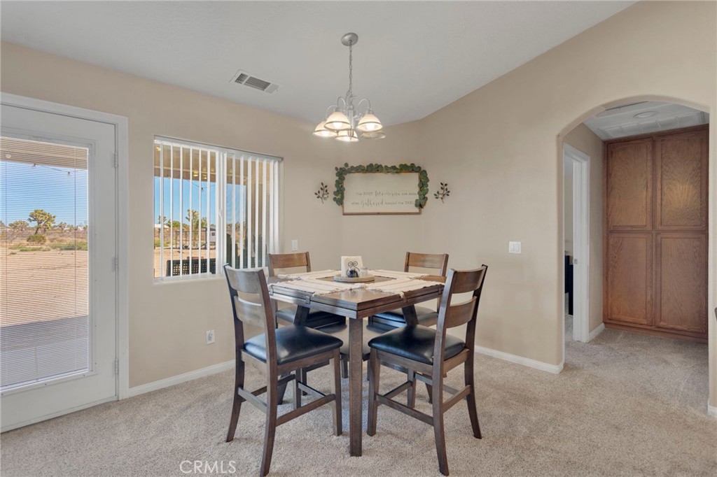 12871 Alta Vista Road Pinon Hills, CA 92372 - Photo 6 of 40 a view of a dining room with furniture window and wooden floor