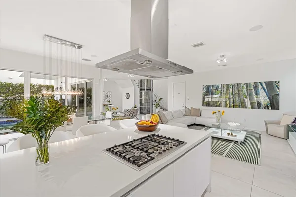 a dining room with furniture and a large window
