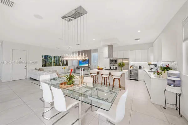 a view of a patio with table and chairs potted plants with swimming pool