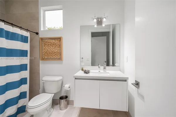 a bathroom with a shower a toilet and a sink