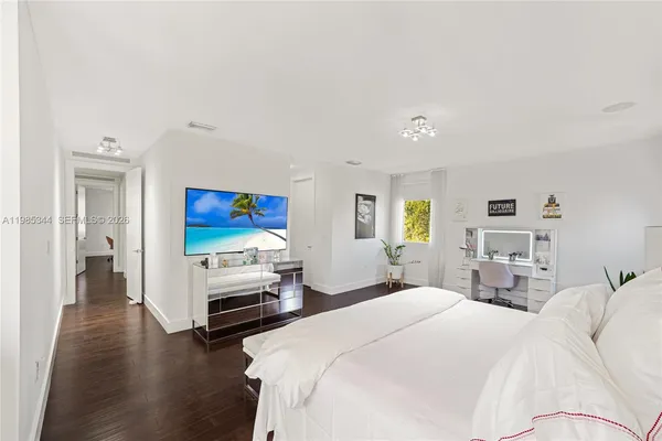 a view of a hallway with wooden floor and stairs