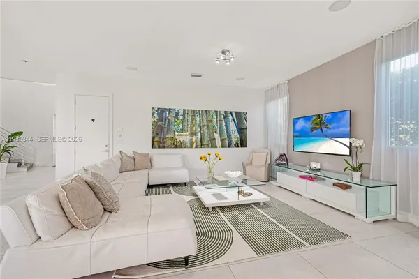a kitchen with appliances cabinets and chairs