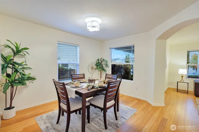 a view of a dining room with furniture and wooden floor
