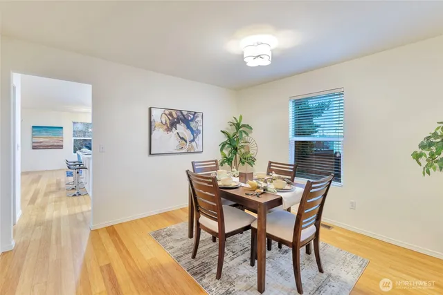 a view of a dining room with furniture and wooden floor