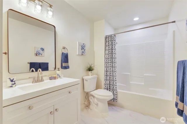 a bathroom with a sink mirror toilet and bathtub