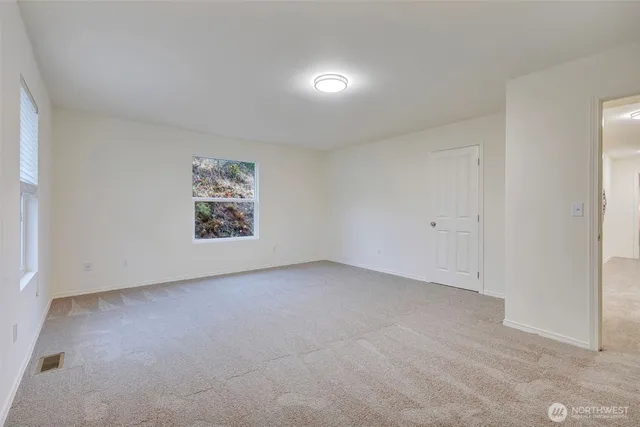 a view of a livingroom with furniture and a window