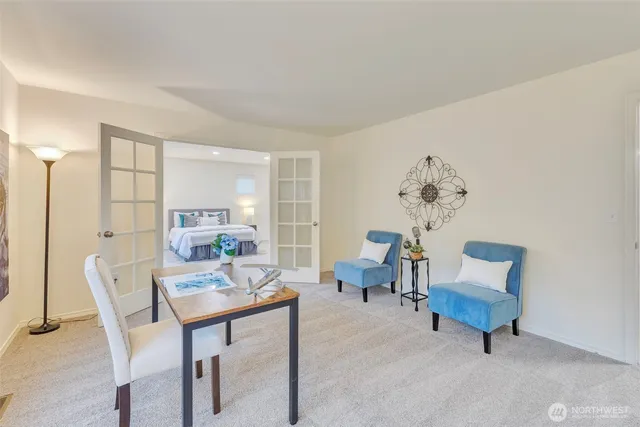 a spacious bedroom with a large bed and a potted plant