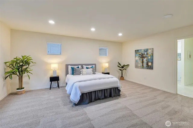 a spacious bedroom with a bed and a large window