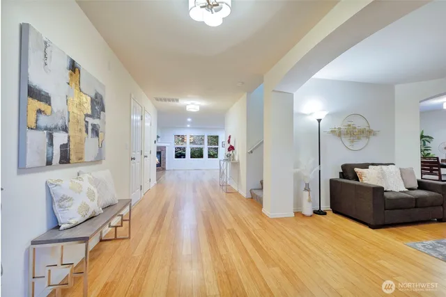 a living room with furniture and a wooden floor