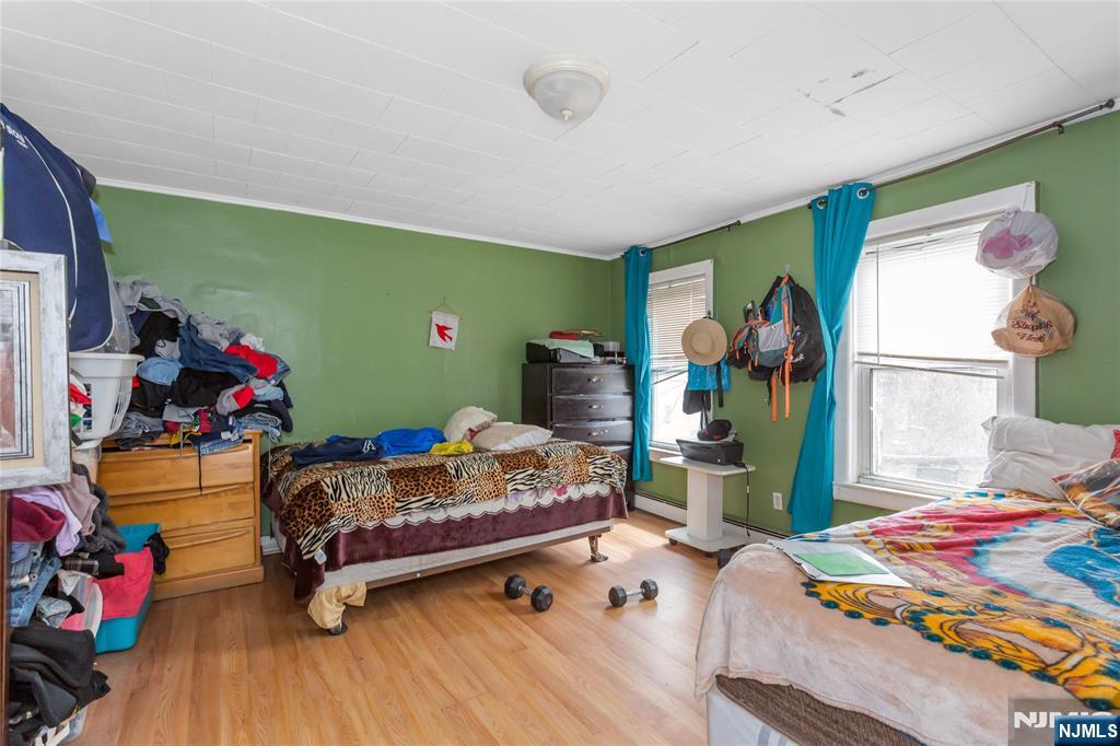 120-122 Lodi Street Hackensack, NJ 07601 - Photo 11 of 50 a bedroom with baby bed and a window