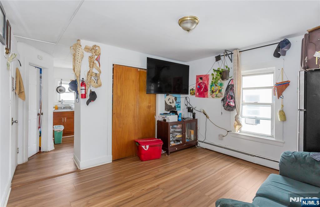 120-122 Lodi Street Hackensack, NJ 07601 - Photo 13 of 50 a view of a livingroom with wooden floor and a window