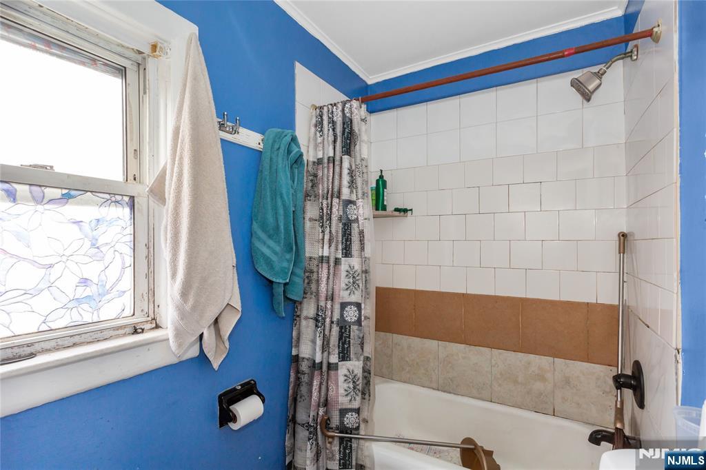 120-122 Lodi Street Hackensack, NJ 07601 - Photo 16 of 50 a bathroom with a tub and a window