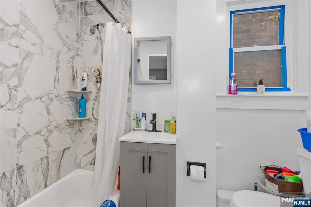 120-122 Lodi Street Hackensack, NJ 07601 - Photo 22 of 50 a bathroom with a sink and a mirror with toilet