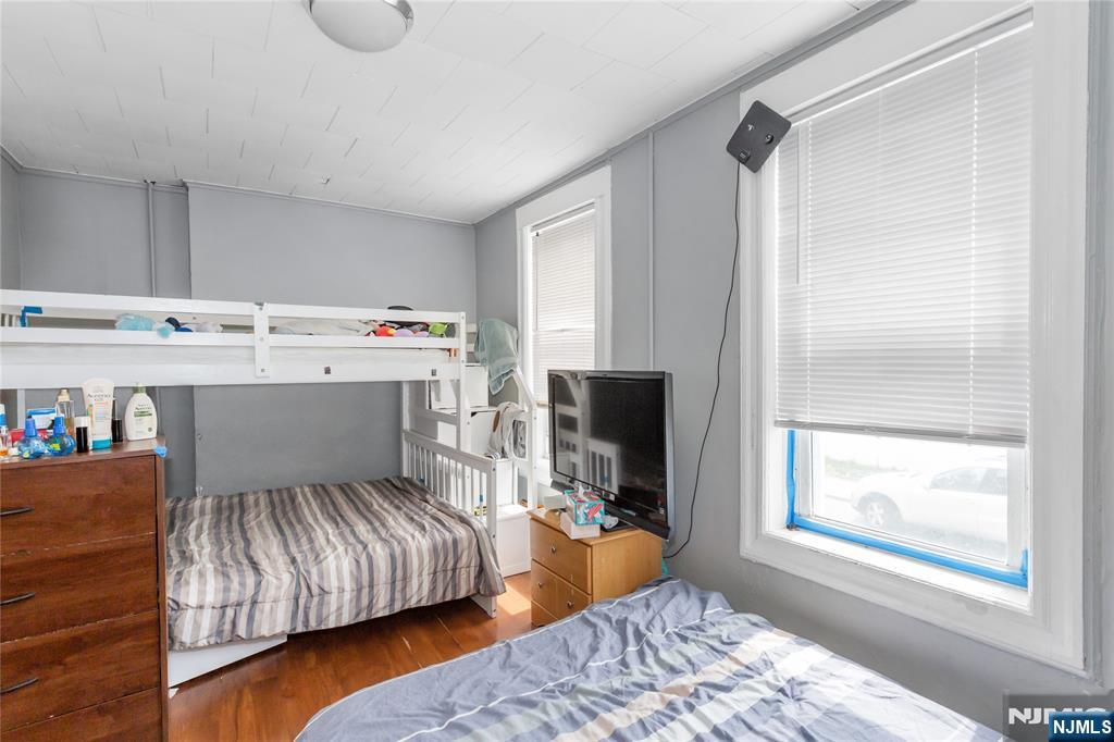 120-122 Lodi Street Hackensack, NJ 07601 - Photo 24 of 50 a bedroom with a bed and a flat screen tv