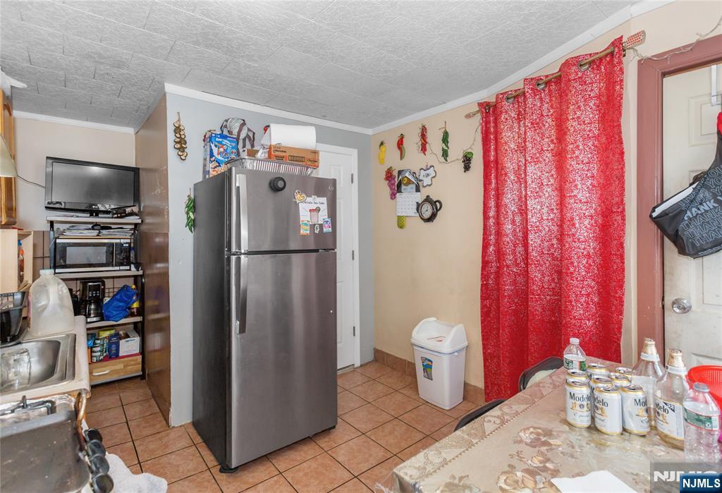 120-122 Lodi Street Hackensack, NJ 07601 - Photo 26 of 50 a kitchen with stainless steel appliances a refrigerator and a stove top oven