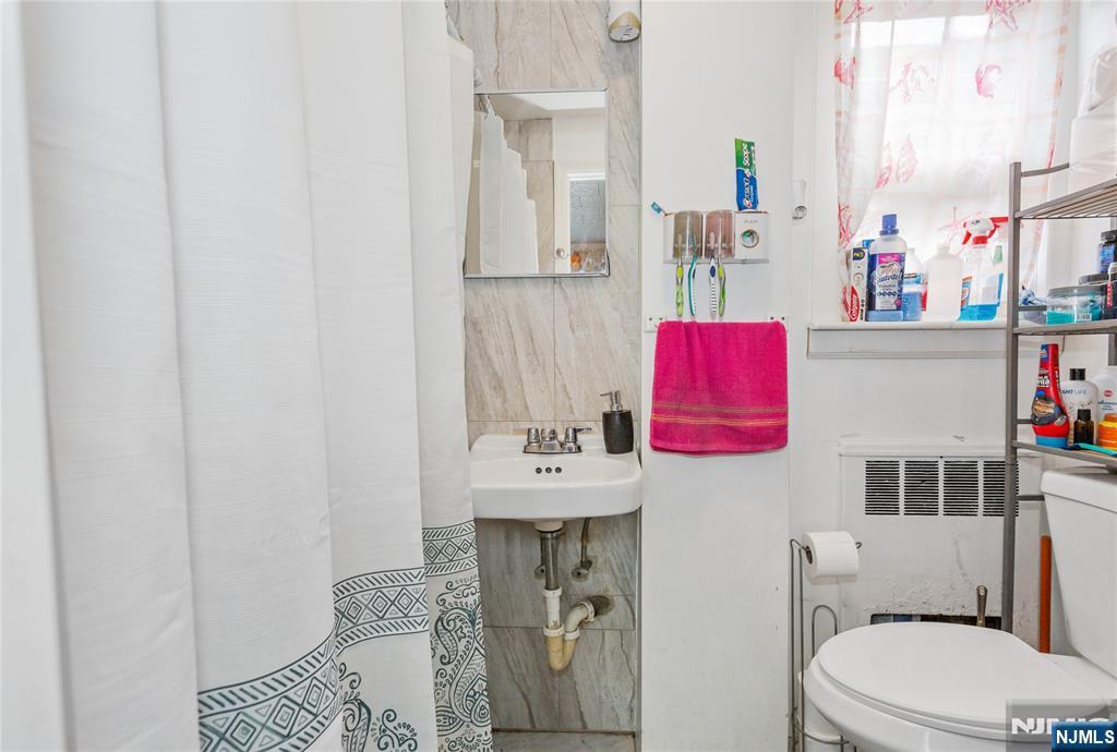 120-122 Lodi Street Hackensack, NJ 07601 - Photo 30 of 50 a bathroom with a sink toilet and shower