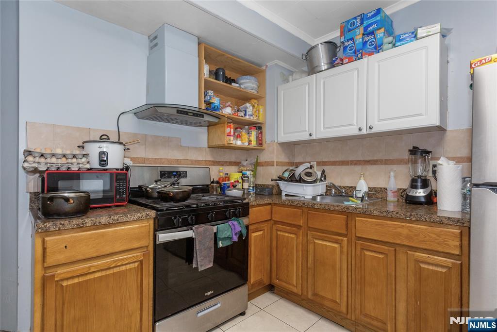 120-122 Lodi Street Hackensack, NJ 07601 - Photo 33 of 50 a kitchen with stainless steel appliances granite countertop a sink stove and cabinets