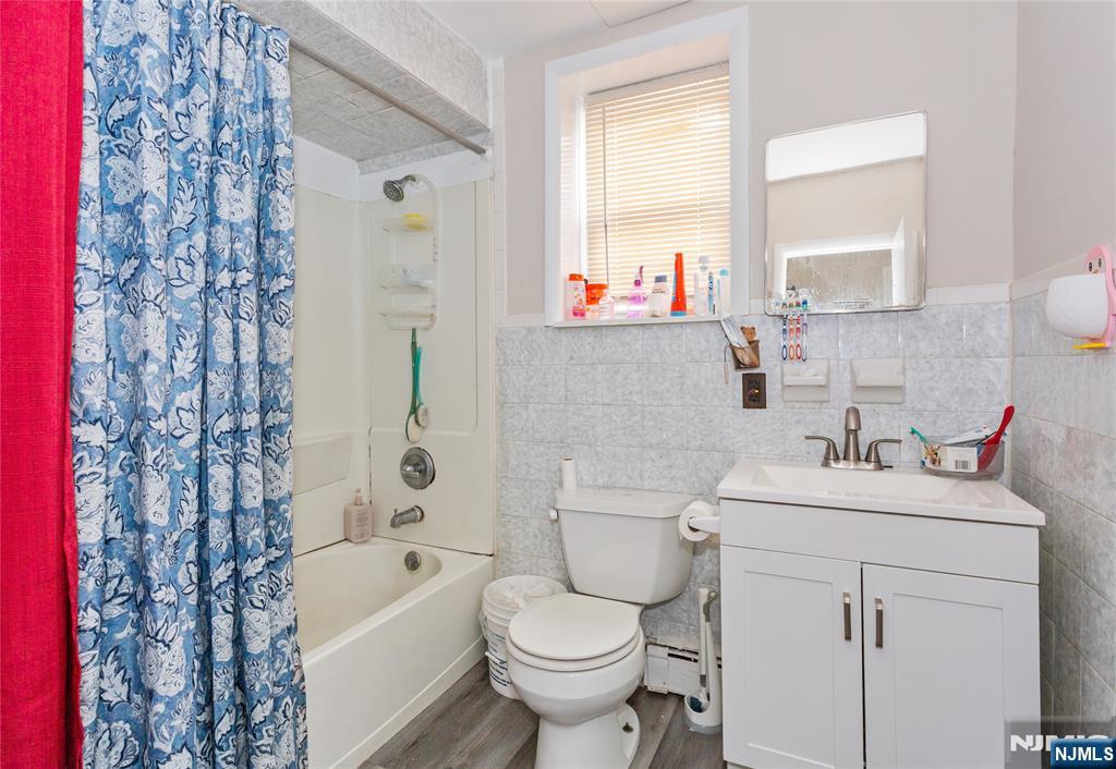 120-122 Lodi Street Hackensack, NJ 07601 - Photo 39 of 50 a bathroom with a sink toilet vanity and bathtub