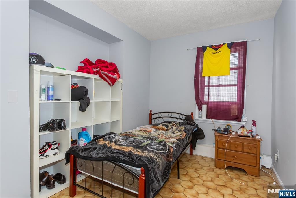 120-122 Lodi Street Hackensack, NJ 07601 - Photo 42 of 50 a bedroom with a bed and dresser