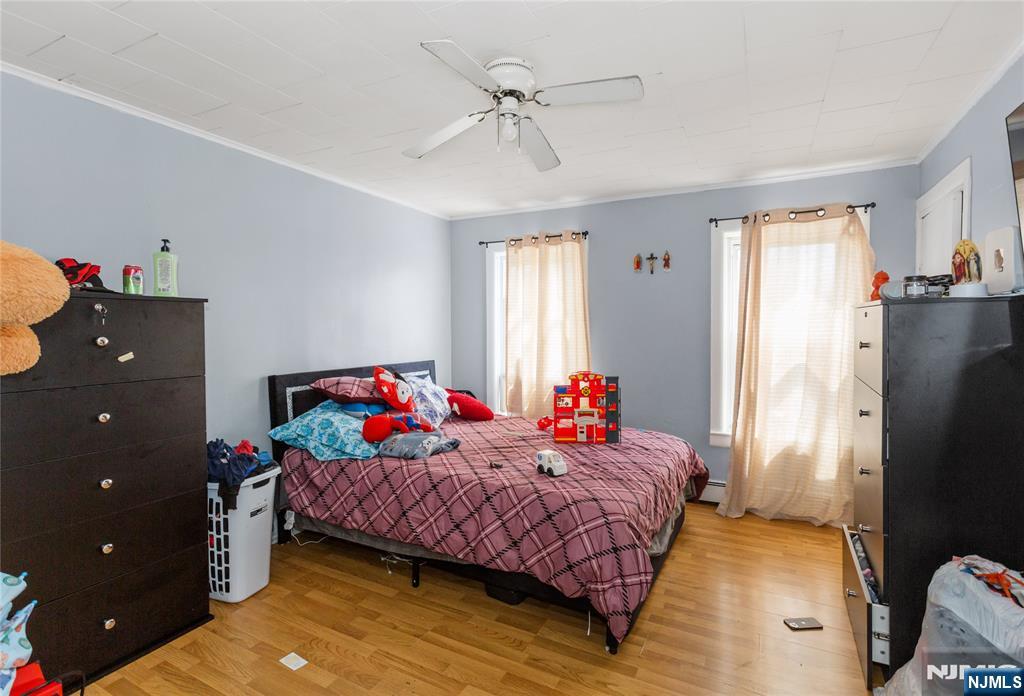 120-122 Lodi Street Hackensack, NJ 07601 - Photo 8 of 50 a bedroom with a bed and a chandelier