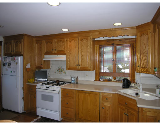 72 Walnut Street Needham, MA 02492 - Photo 12 of 16 a kitchen with kitchen island granite countertop a sink cabinets and stainless steel appliances