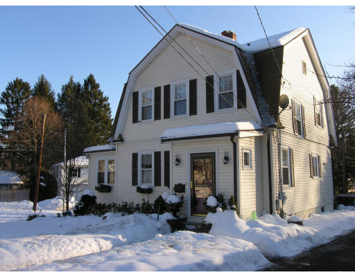 72 Walnut Street Needham, MA 02492 - Photo 3 of 16 a view of a white house with many windows next to a yard