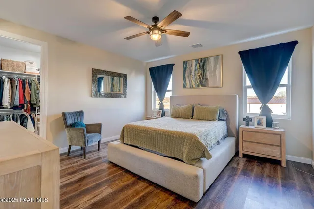a bedroom with a bed and a flat tv screen on dresser