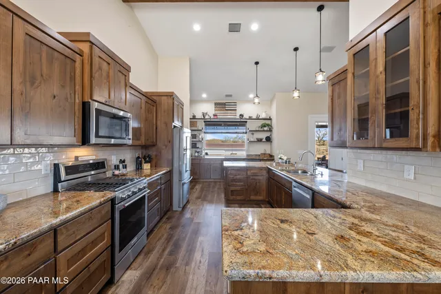 a view of a dining room with furniture a fireplace and a flat screen tv