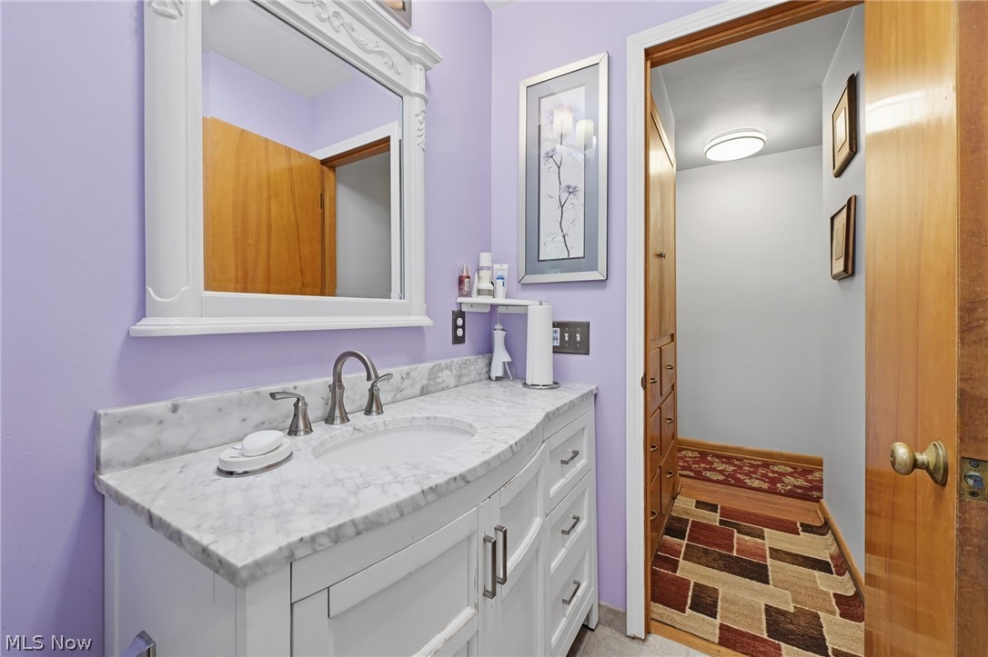 1499 Morris Road Kent, OH 44240 - Photo 7 of 41 Bathroom vanity featuring a white cabinet base with drawer storage, a single undermount sink, and a white stone countertop